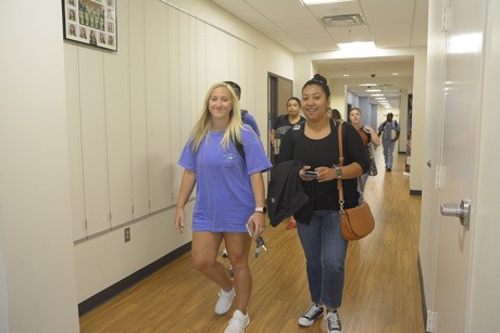Photo of smiling faces on first day in the James A. Walters Allied Health Building.