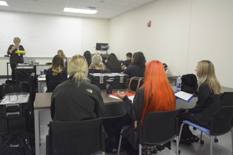 Photo of Cosmetology students showing a flair for hair color on the first day of classes.