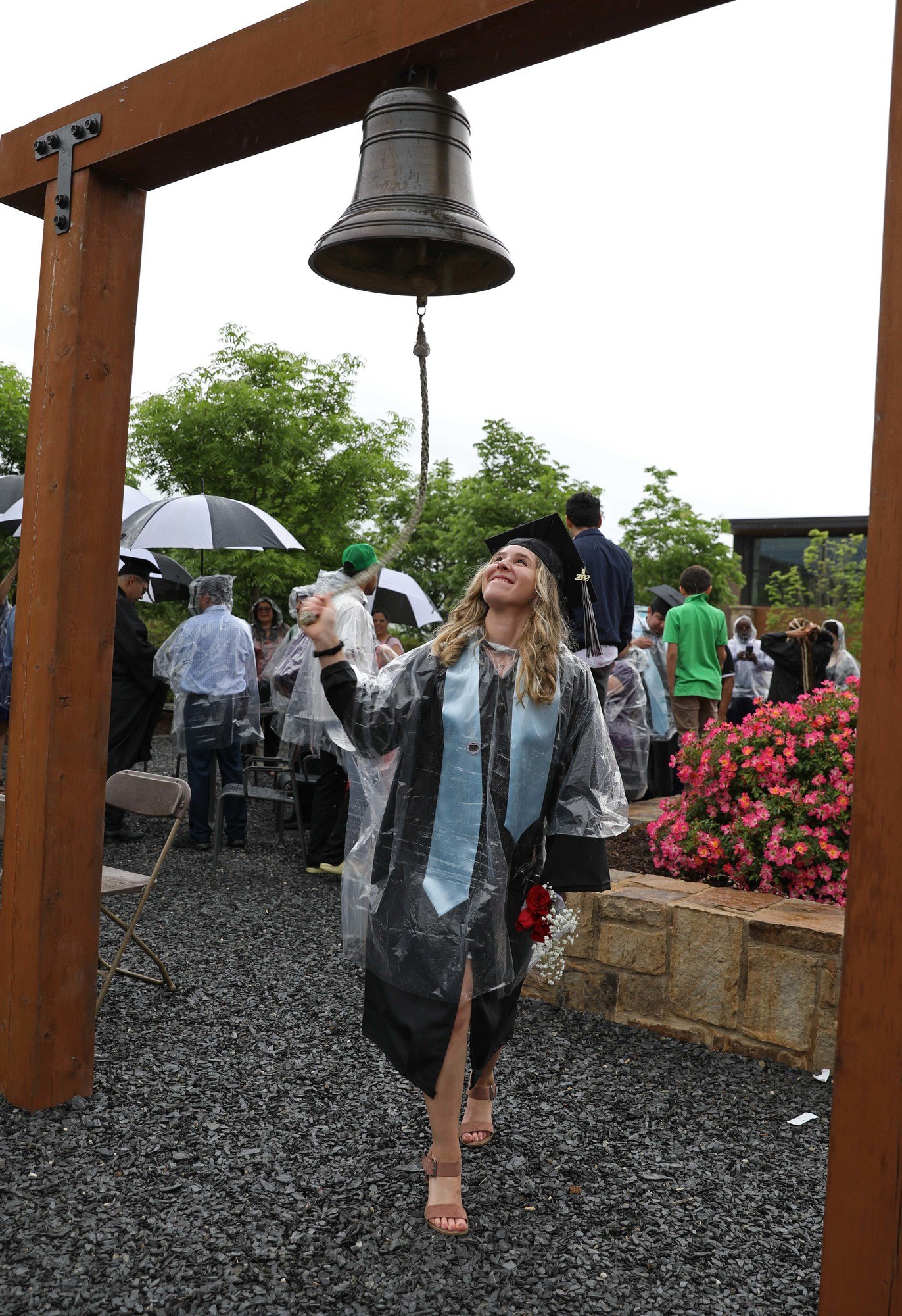Graduate ringing bell at 56th Annual Commencement Ceremony