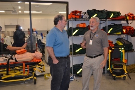Photo of Dr. Gary Kempler and Sam Stone discussing EMS protocols in the Paramedicine Lab.
