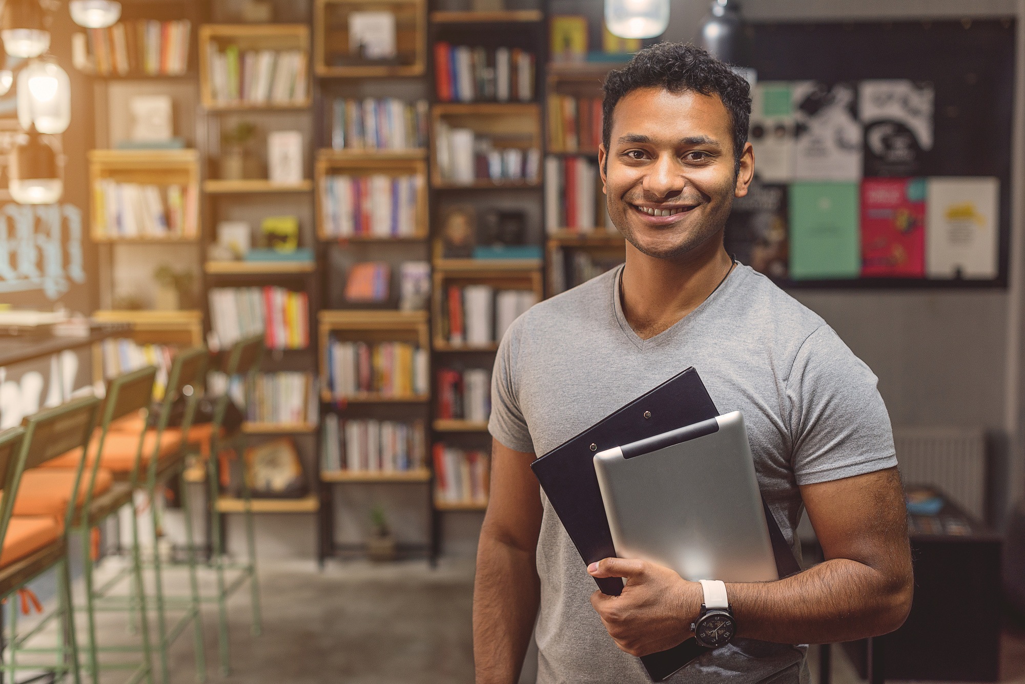 African man standing in campus library