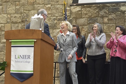 Photo of Annette Baker learning of award and being congratulated by Dr. Ray Perren, Lanier Technical College President.