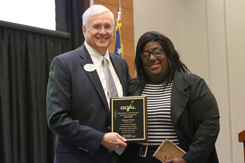 Britany Parke (right) receives her award from Lanier Tech President, Tim McDonald (left).