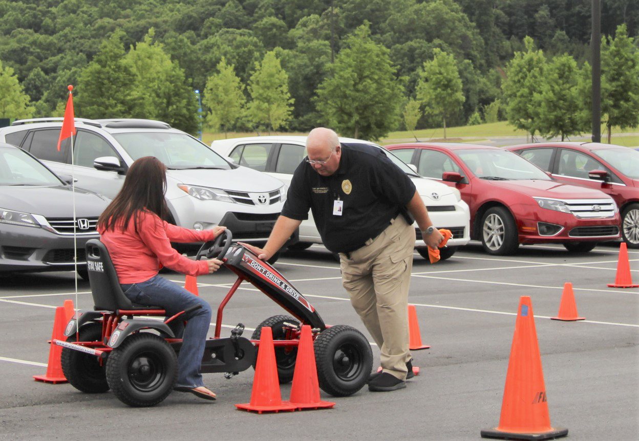Lanier Tech Chief of Police, Jeff Strickland, assists an “impaired” student driver.