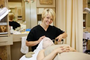 Esthetician student giving a facial