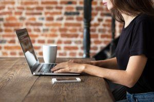 Girl working on laptop at table