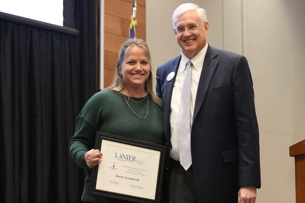 Karen Nowakowski (left) receives her award from Lanier Tech President, Tim McDonald (right).