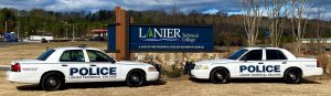 Police Cars in front of sign