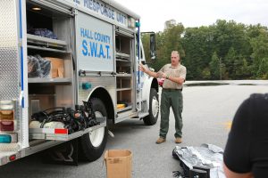Officer standing beside Hall County SWAT vehicle