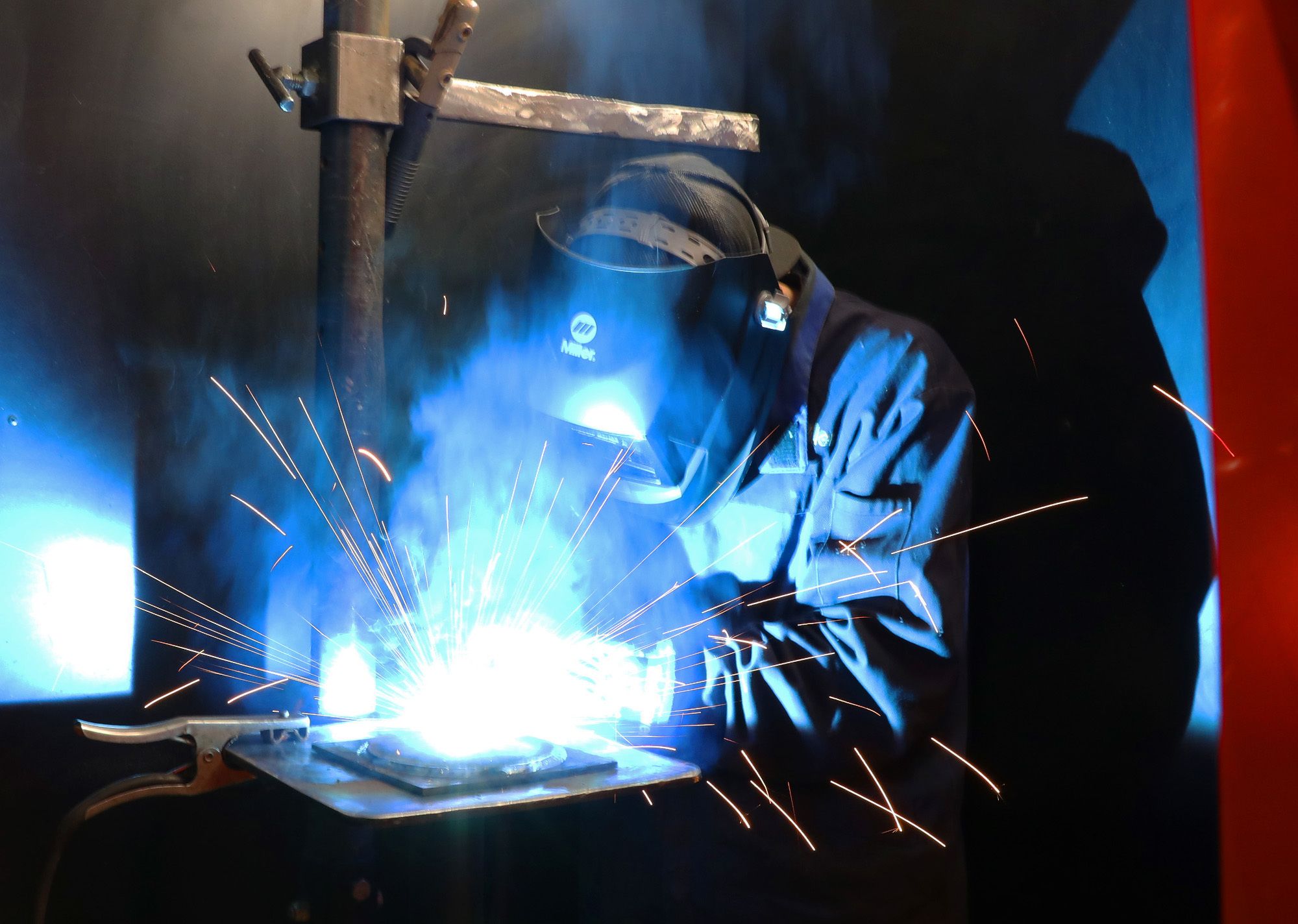 Student welding and sparks are flying
