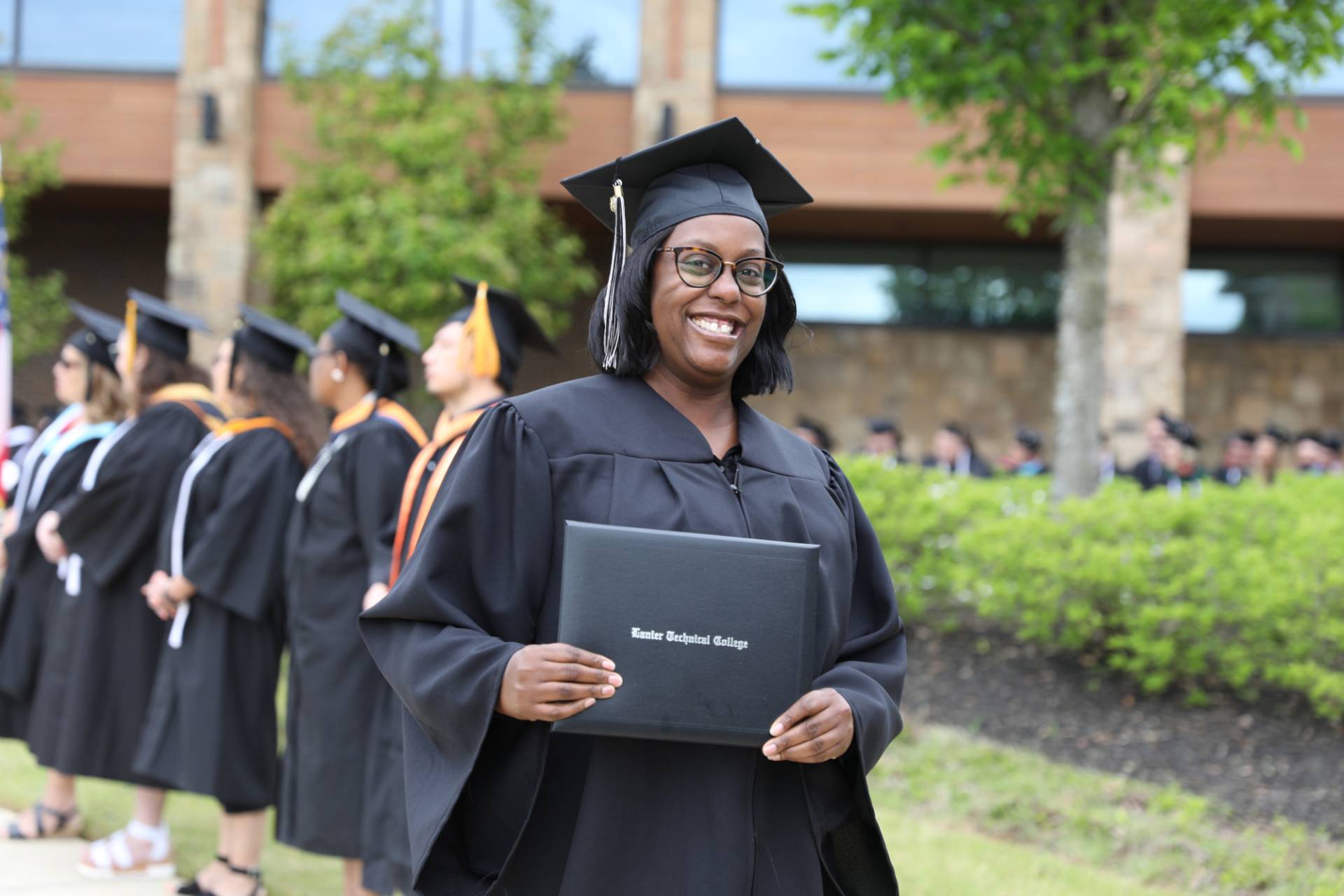 graduate holding diploma