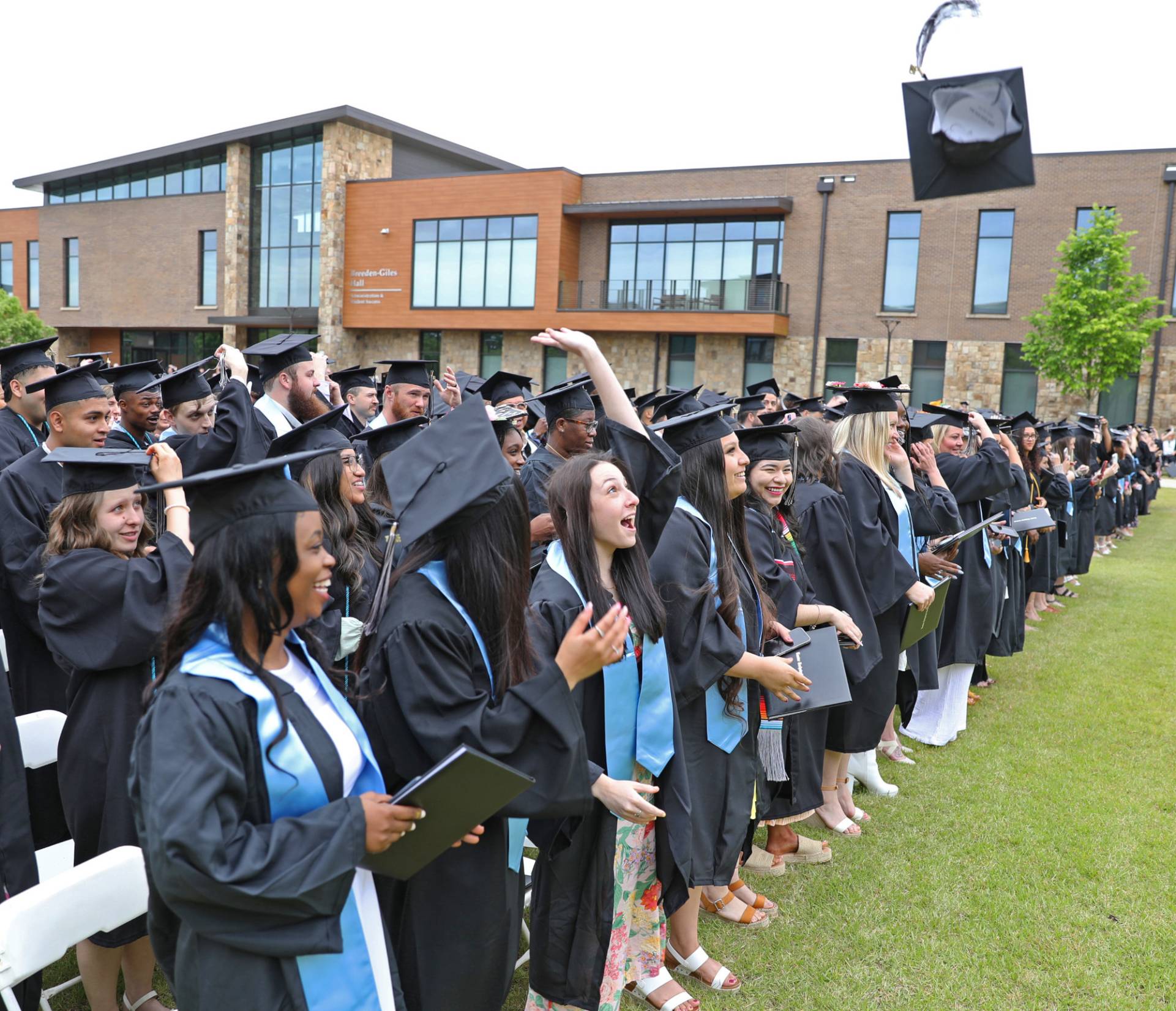 graduates tossing caps in the air